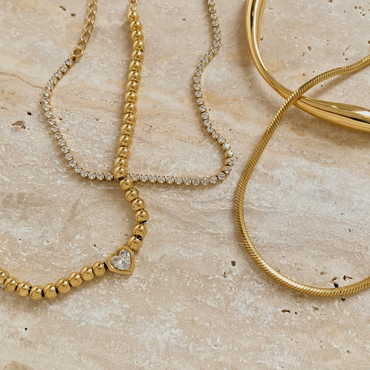 Vergoldetes Damenarmband mit feinen Kugel-Details und Herz-Charms von Finesse Feminine Jewelry